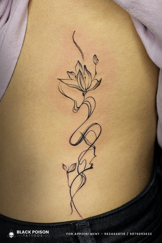 Elegant Lotus Fine Line Tattoo on Ribcage
