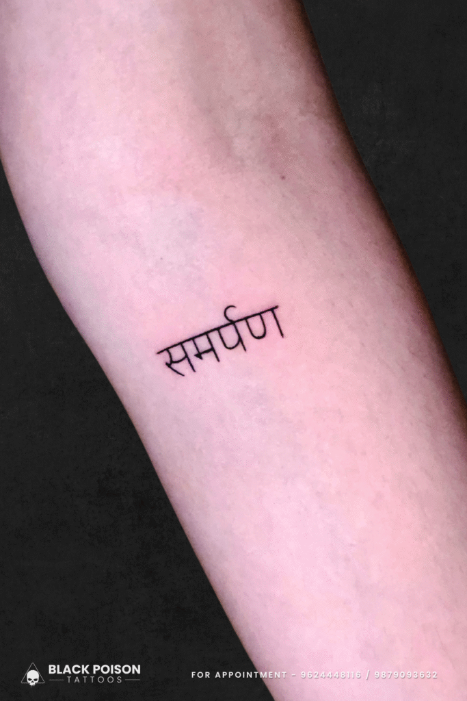 Samarpan Hindi word tattoo on inner forearm