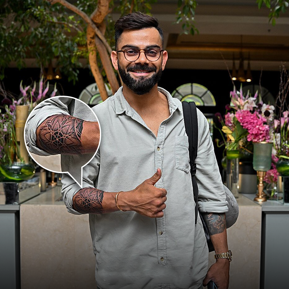 Virat Kohli showing off a fresh mandala geometric tattoo on his forearm with a thumbs-up gesture