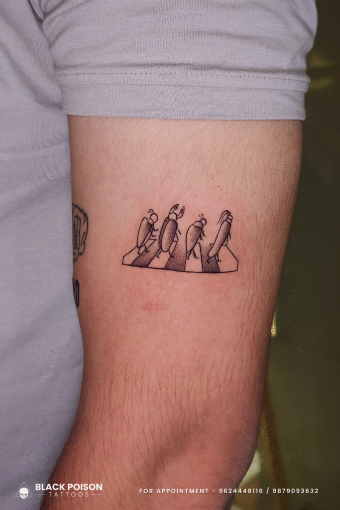 Minimalist beetle Abbey Road tattoo on upper arm at Black Poison Tattoos Ahmedabad Gujarat