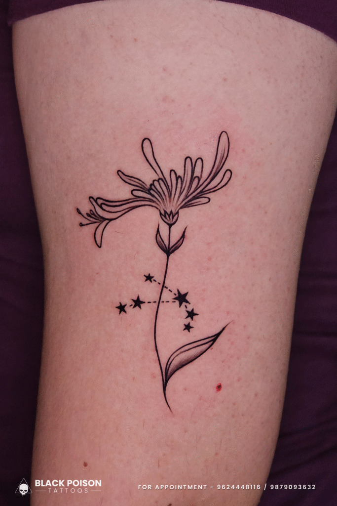 Floral tattoo with constellation design on upper arm by Black Poison Tattoos Ahmedabad