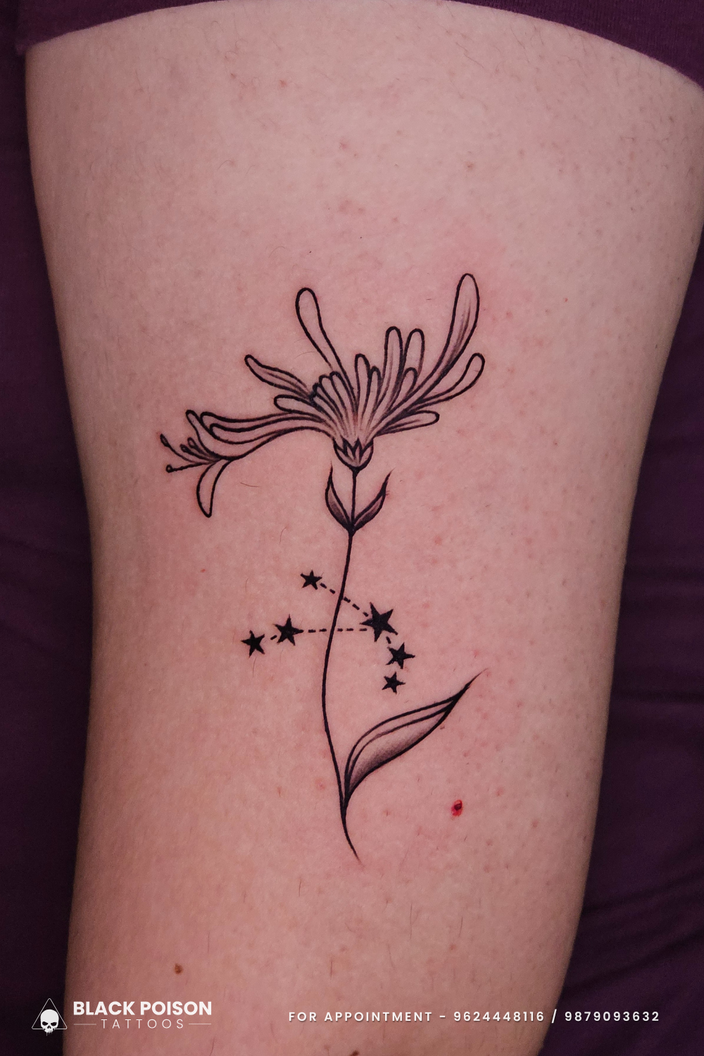 Floral tattoo with constellation design on upper arm by Black Poison Tattoos Ahmedabad