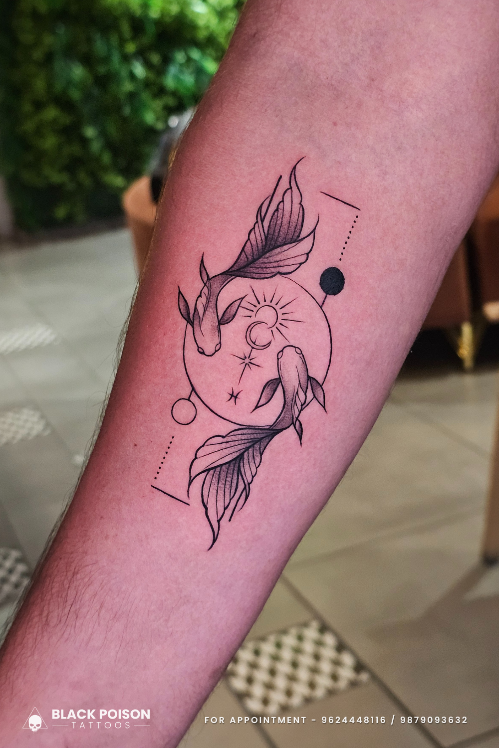 koi fish celestial fine-line tattoo on forearm at Black Poison Tattoos Ahmedabad