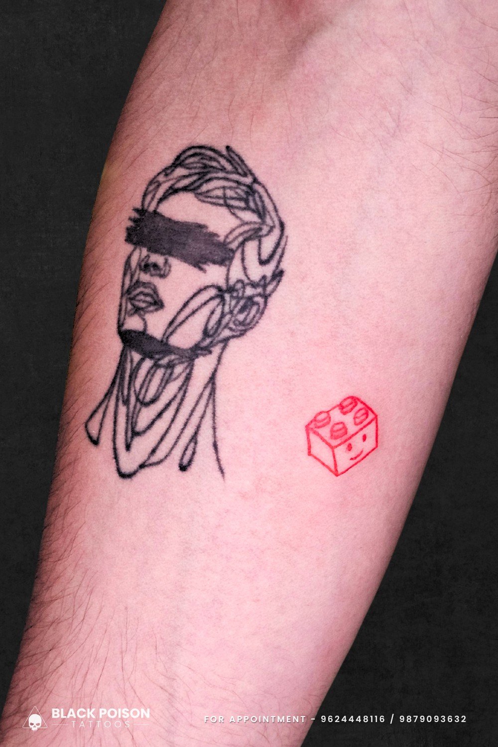 minimalist portrait forearm tattoo with playful red brick design