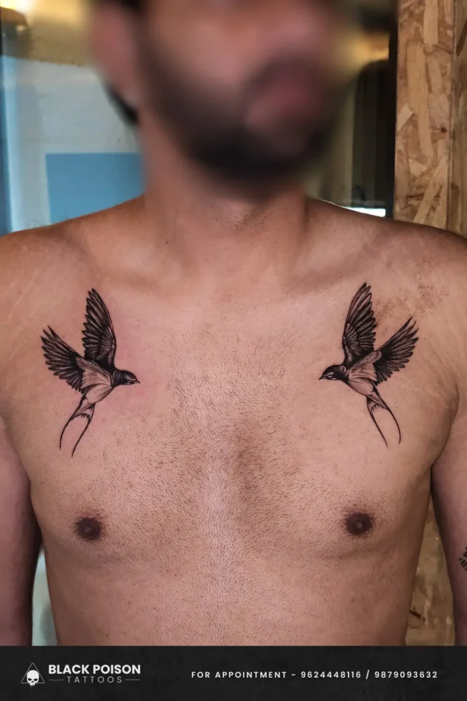 Symmetrical black and grey swallow bird tattoo on the chest done at Black Poison Tattoos in Ahmedabad.