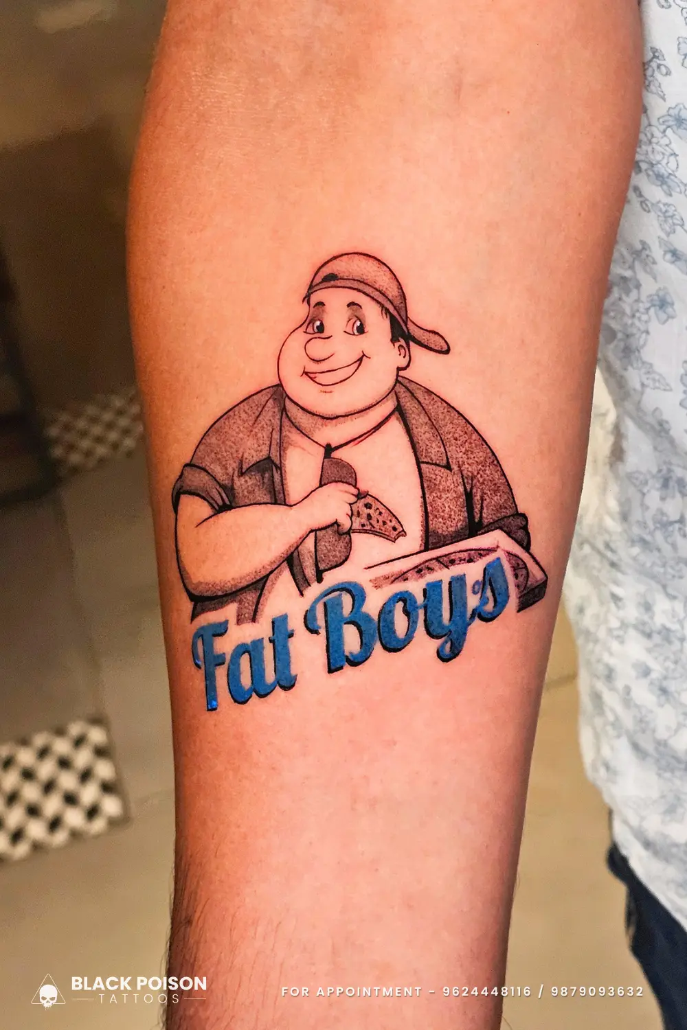 Custom illustrative cartoon tattoo of the Fat Boy's pizza mascot with blue lettering on a forearm by Black Poison Tattoo Studio Ahmedabad.