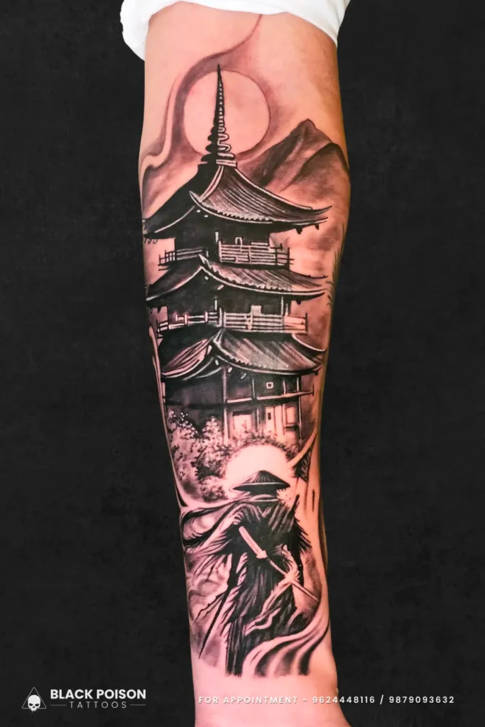 Detailed black and grey realism tattoo of a samurai warrior standing before a traditional Japanese pagoda on a forearm by Black Poison Tattoo Studio Ahmedabad.