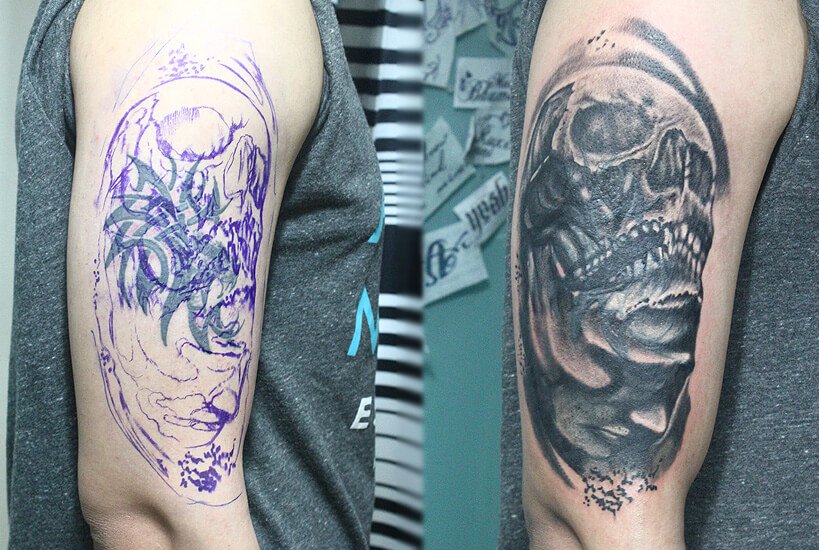 Cover up tattoo reworked into a black and grey skull and dragon sleeve