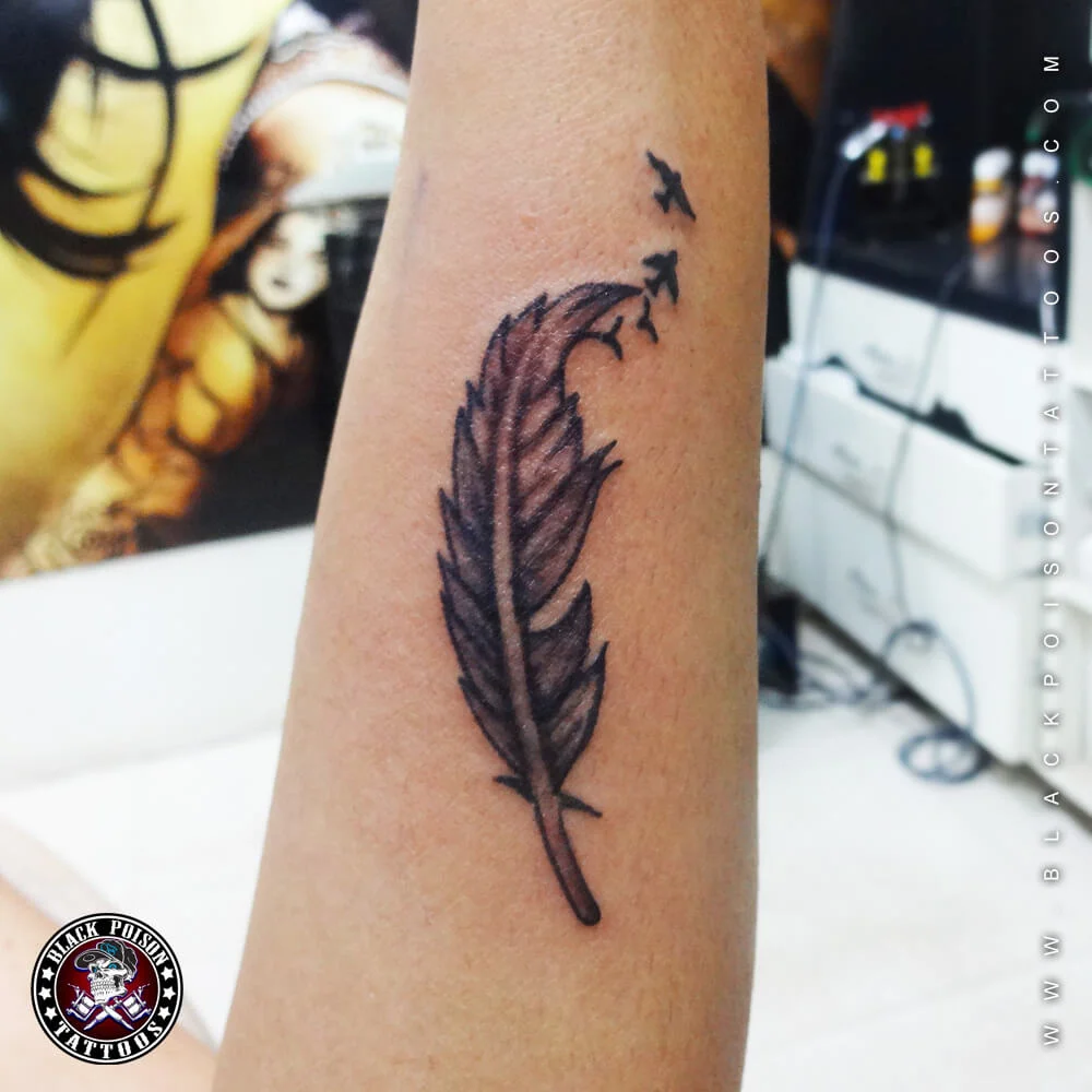 Feather tattoo with birds flying - forearm