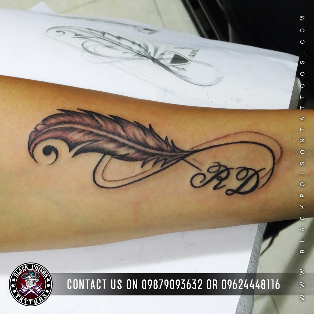 Realistic feather tattoo on upper back