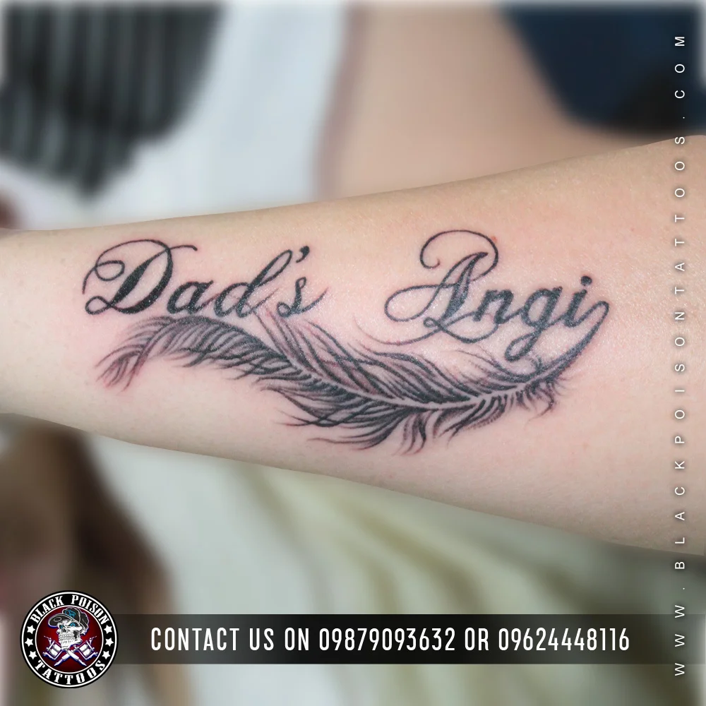 Fine line feather tattoo with Dad's Angi lettering on the inner forearm
