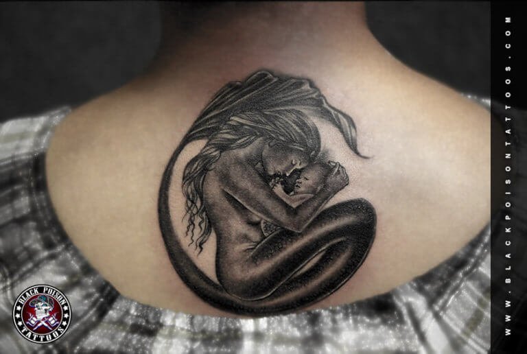 Black and grey mother and child embrace tattoo on the upper back