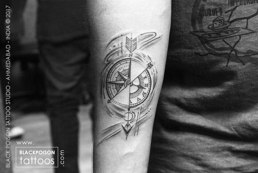 Black and grey compass and map tattoo on the forearm
