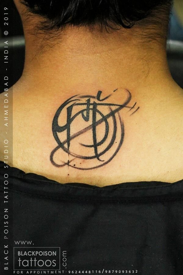 Ornate calligraphy monogram tattoo on the back of the neck