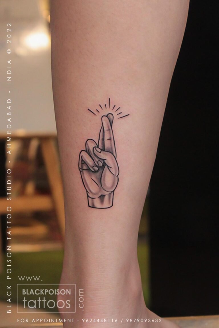 Fine line crossed fingers hand tattoo on the forearm