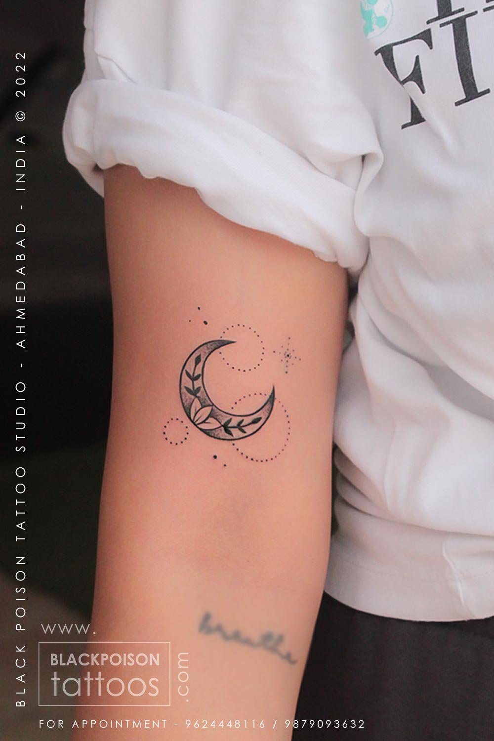 Fine line crescent moon and stars tattoo on the upper arm