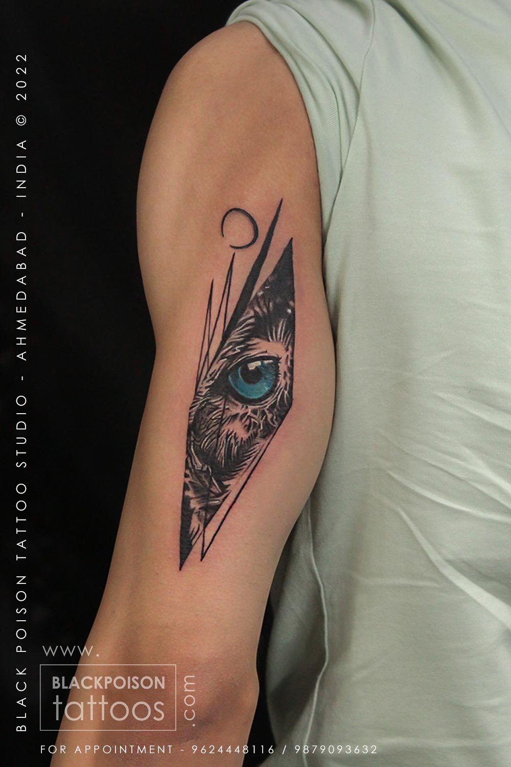 Geometric owl and eye tattoo in a diamond frame on the upper arm