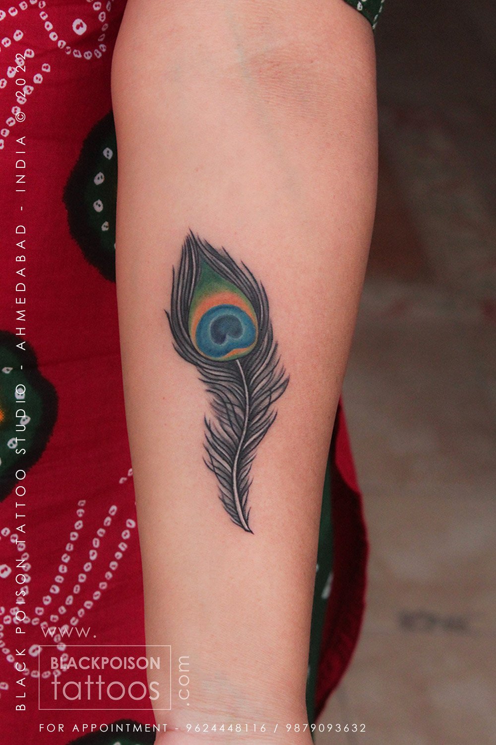Colorful feather tattoo on forearm - Black Poison Tattoo Studio Ahmedabad