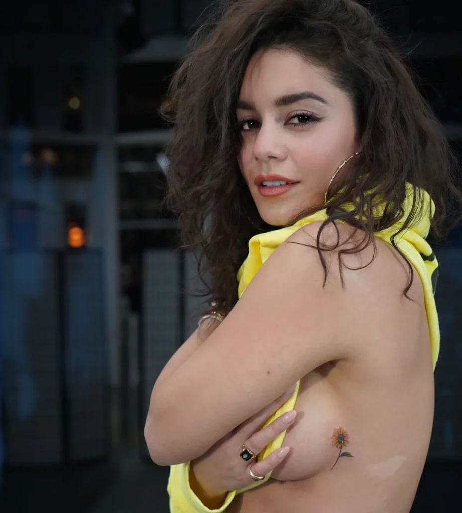 Vanessa Hudgens showing a small tattoo on her side