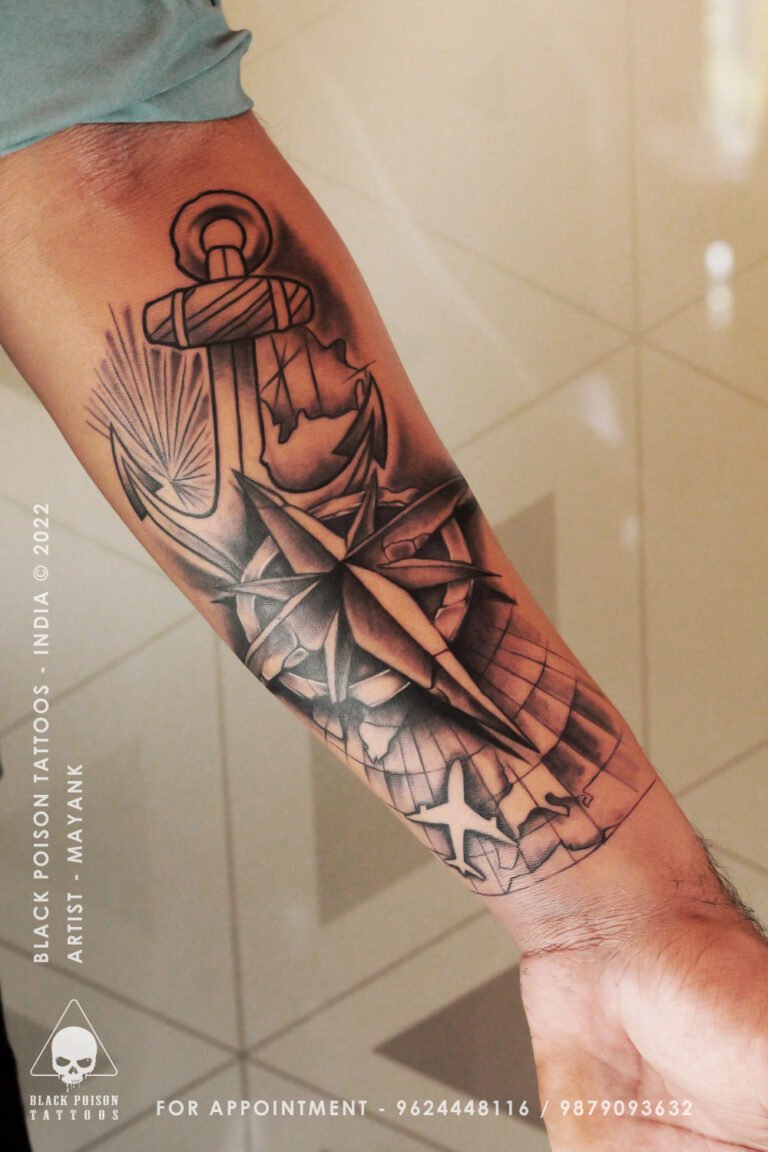 Black and grey forearm tattoo with an anchor, compass and geometric shapes
