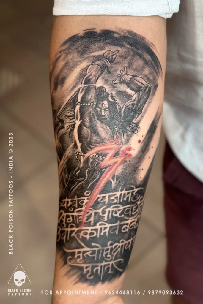 Forearm tattoo of a deity with Sanskrit shloka lettering in red and black