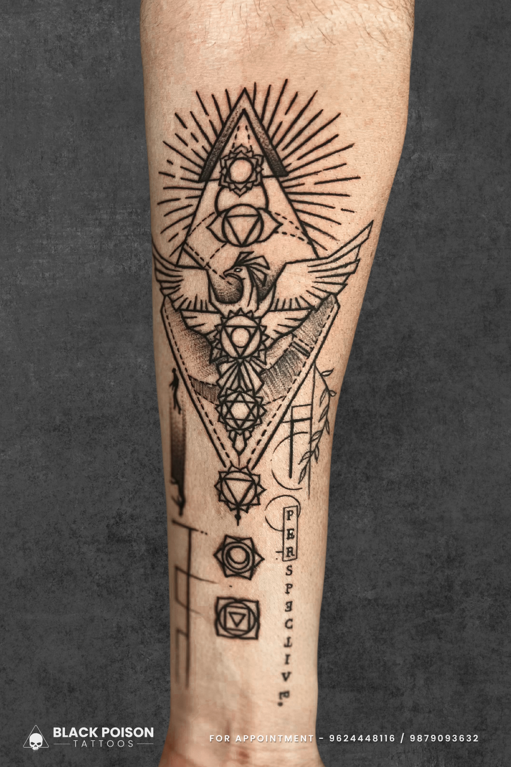 Forearm Tattoo with Phoenix and Chakra Symbols