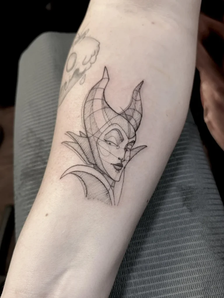 Minimal fine line Maleficent outline tattoo on the forearm
