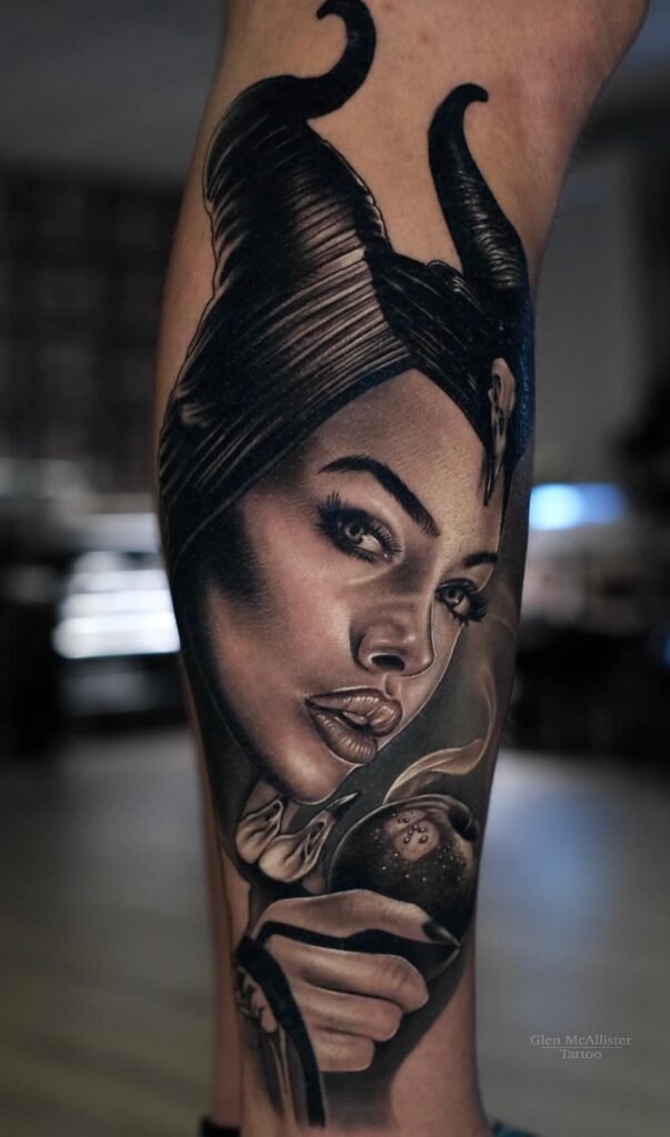 Realistic black and grey Maleficent portrait tattoo covering the forearm