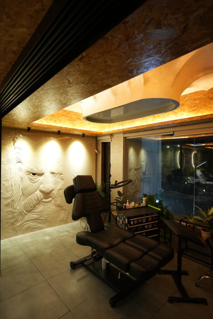 Tattoo and piercing room at Black Poison Tattoo Studio with treatment chair and feature lighting
