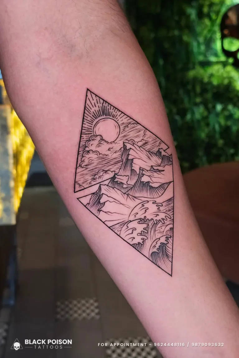 Fine line geometric landscape tattoo featuring mountains, sun, and ocean waves inside a split diamond on the forearm, done at Black Poison Tattoo Studio in Ahmedabad.