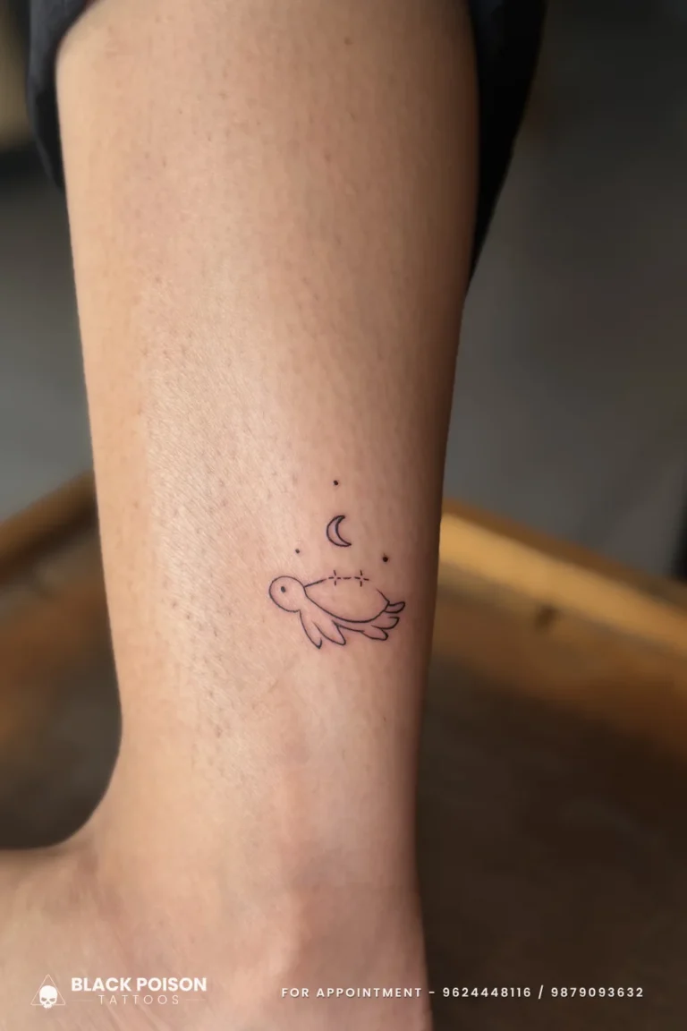 Tiny fine line sea turtle with a crescent moon and star dots tattooed on the inner ankle at Black Poison Tattoo Studio, Ahmedabad