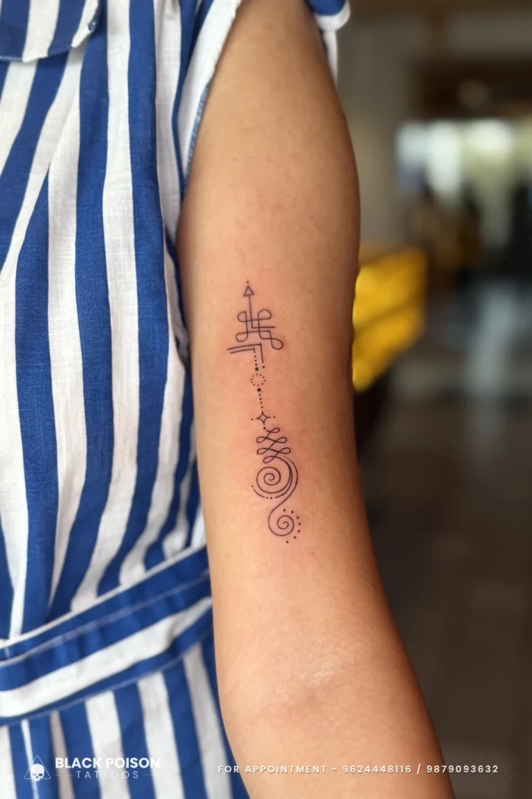 Fine line black unalome tattoo from spiral to crown on the back of the upper arm at Black Poison Tattoo Studio, Ahmedabad