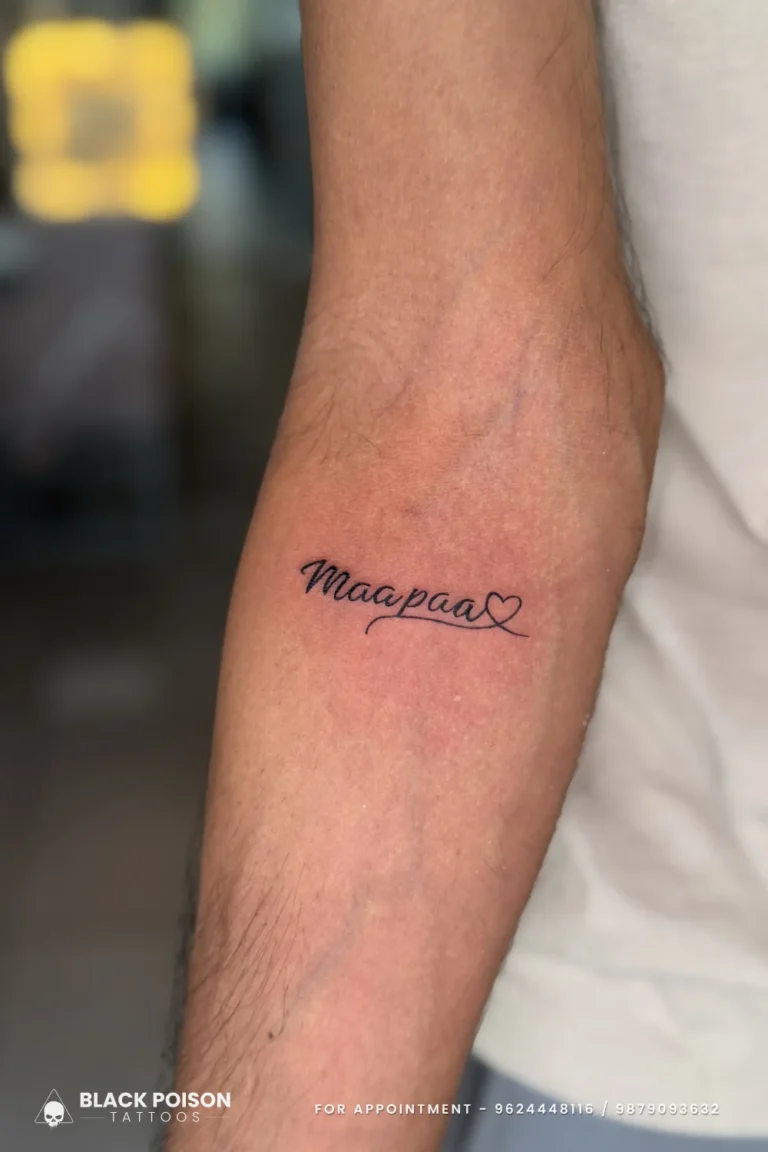 Cursive Maapaa script tattoo with an outlined heart in black on the inner forearm at Black Poison Tattoo Studio, Ahmedabad