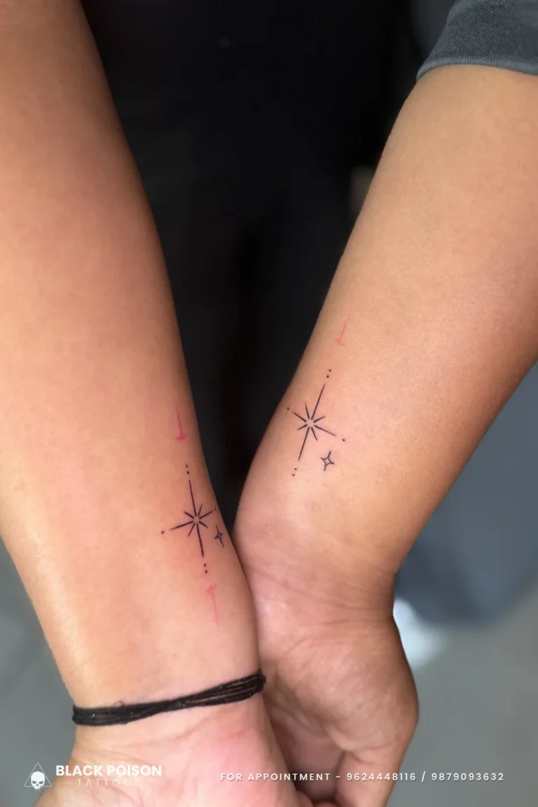 Matching fine line sparkle star tattoos on two inner wrists held together at Black Poison Tattoo Studio, Ahmedabad