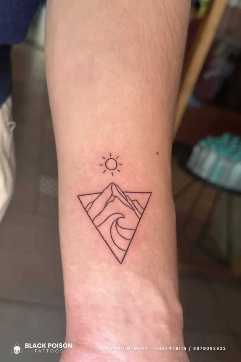 Fine line triangle tattoo with mountain, wave and sun on the inner forearm at Black Poison Tattoo Studio, Ahmedabad
