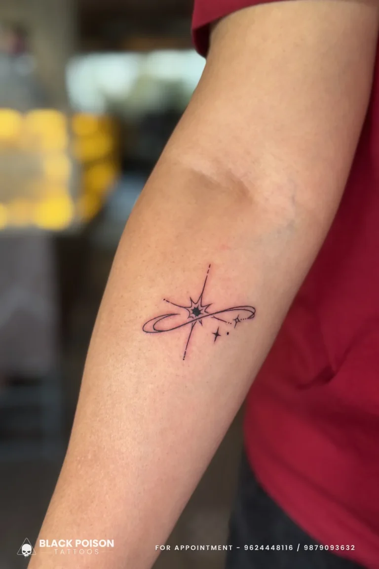Fine line shooting star tattoo in an infinity orbit on the inner forearm at Black Poison Tattoo Studio, Ahmedabad
