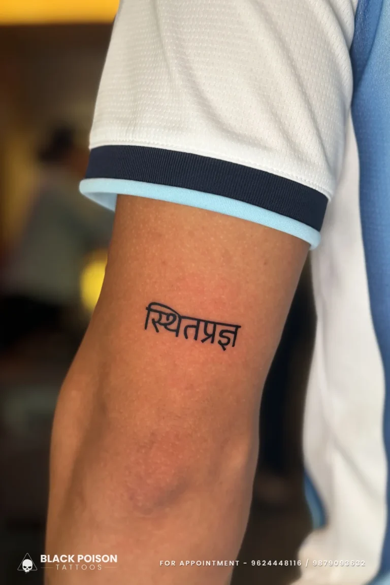 Bold black Devanagari Sthitaprajna Sanskrit tattoo on the outer upper arm at Black Poison Tattoo Studio, Ahmedabad