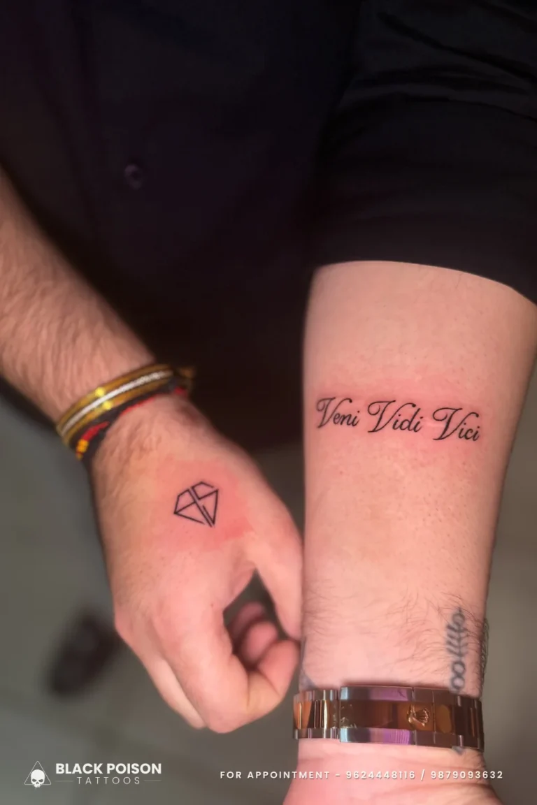 Veni Vidi Vici cursive script on the inner wrist and a fine line diamond on the hand at Black Poison Tattoo Studio, Ahmedabad